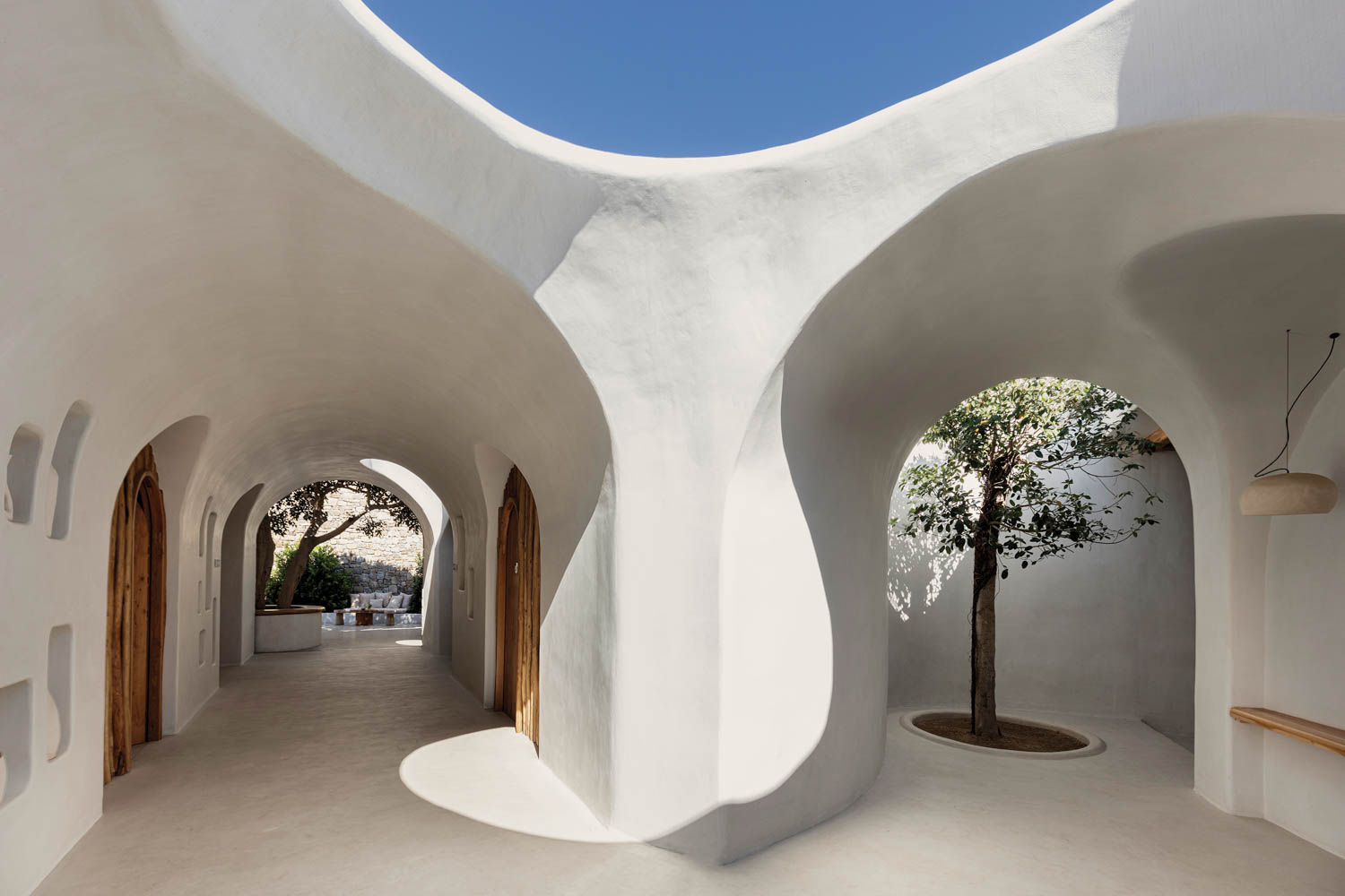 white stone walls form the exterior hallways of Super Paradise Beach Club