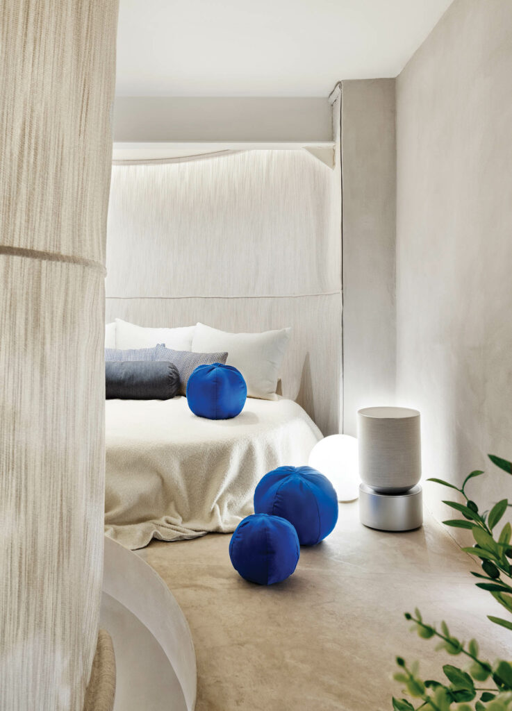 a custom white circular bed with blue circular pillows